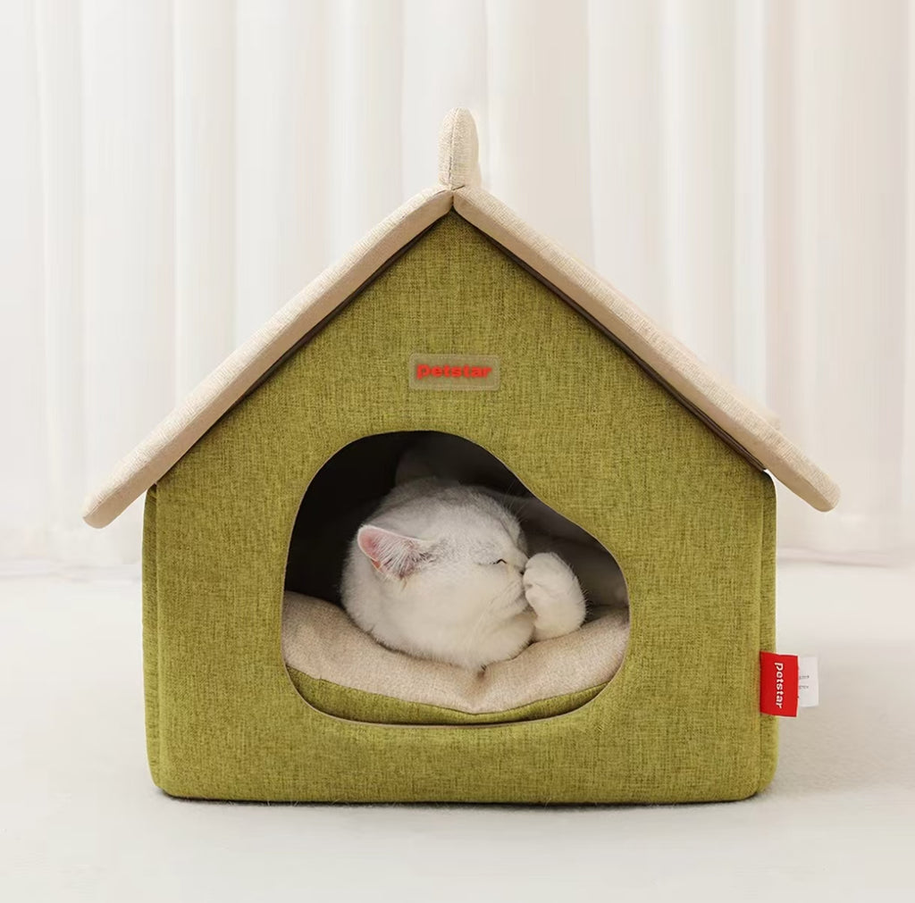 White cat resting on the inner cushion of a Petstar cat house bed