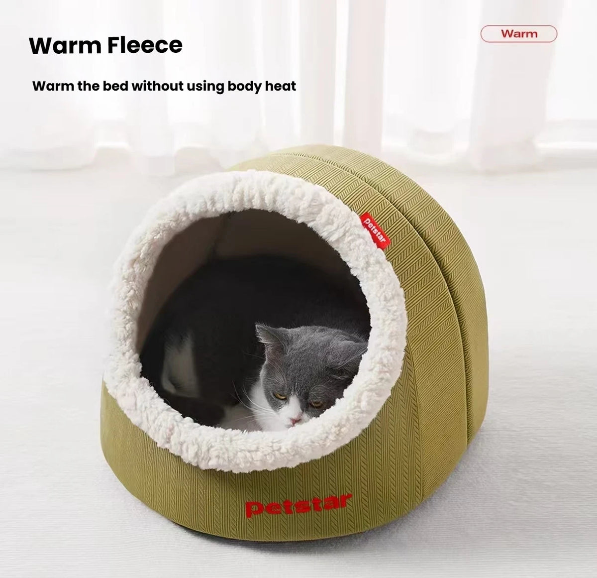 Grey and white cat curled inside a green Petstar cave bed