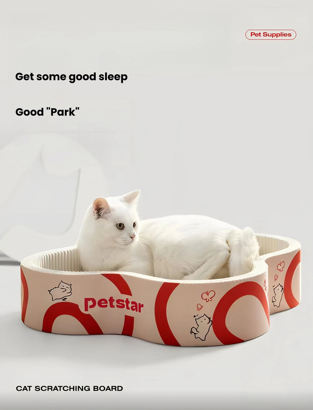White cat resting in a Petstar flower-shaped cardboard scratcher bed
