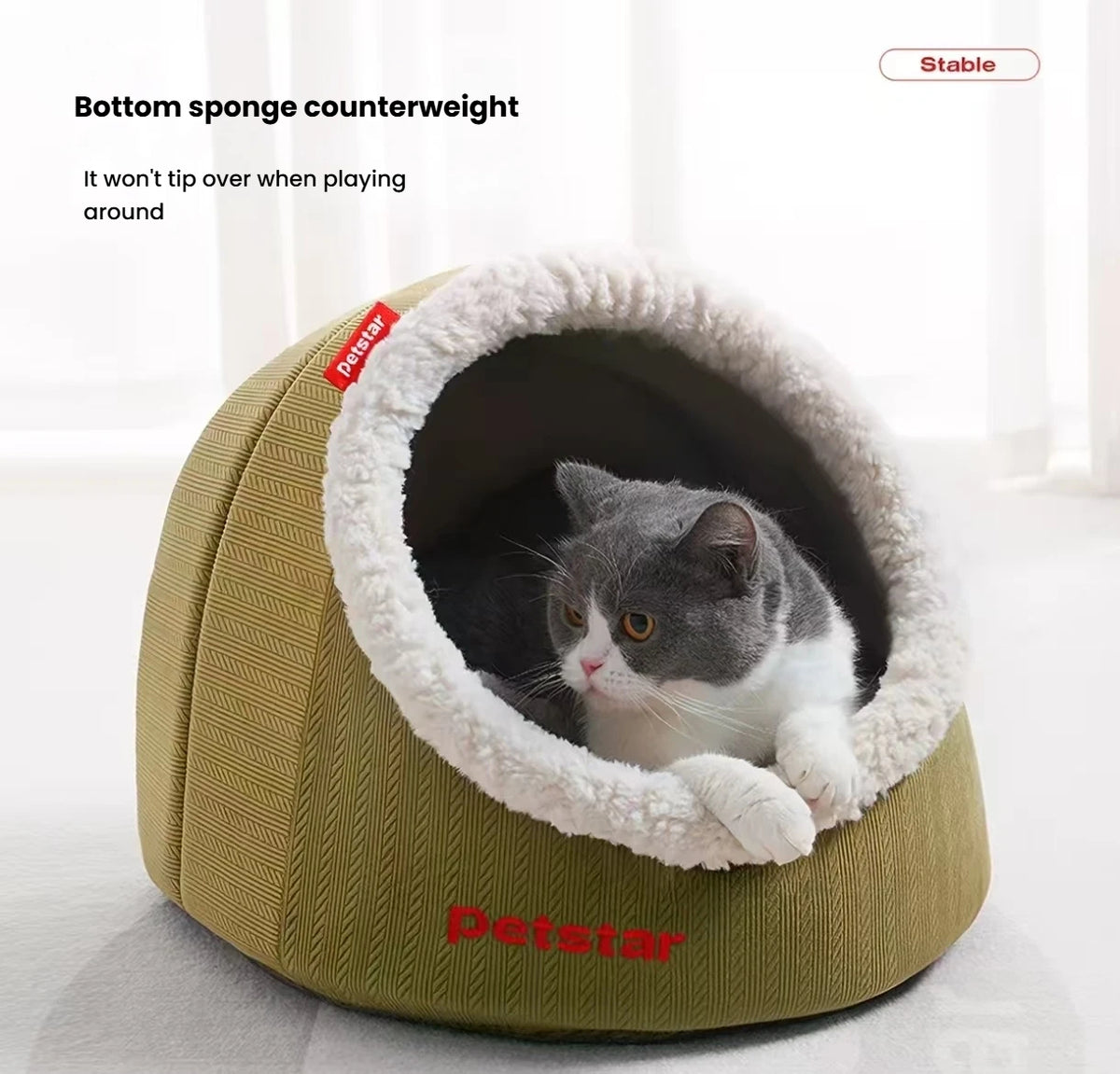 Cat looking out from the soft-lined entrance of a Petstar cave bed