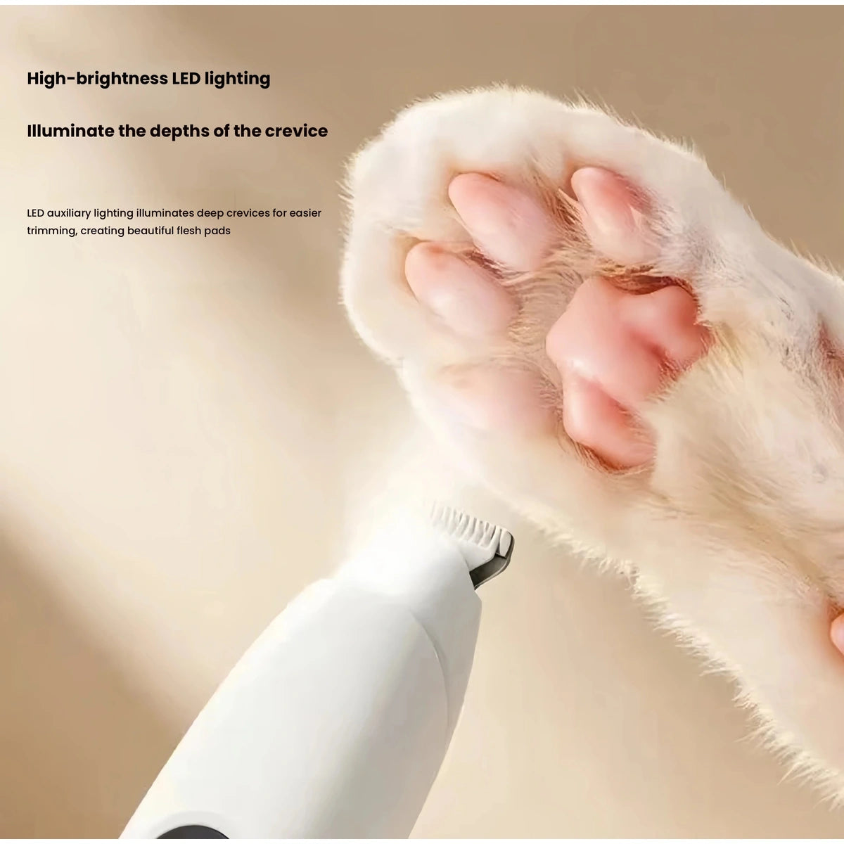 Close-up of white trimmer head beside paw fur