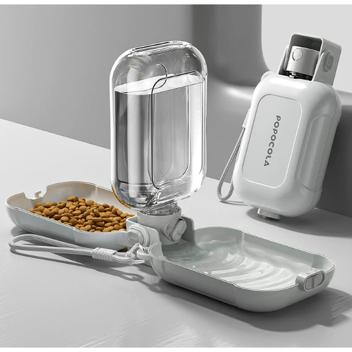 Open bottle showing water bowl and food tray with kibble