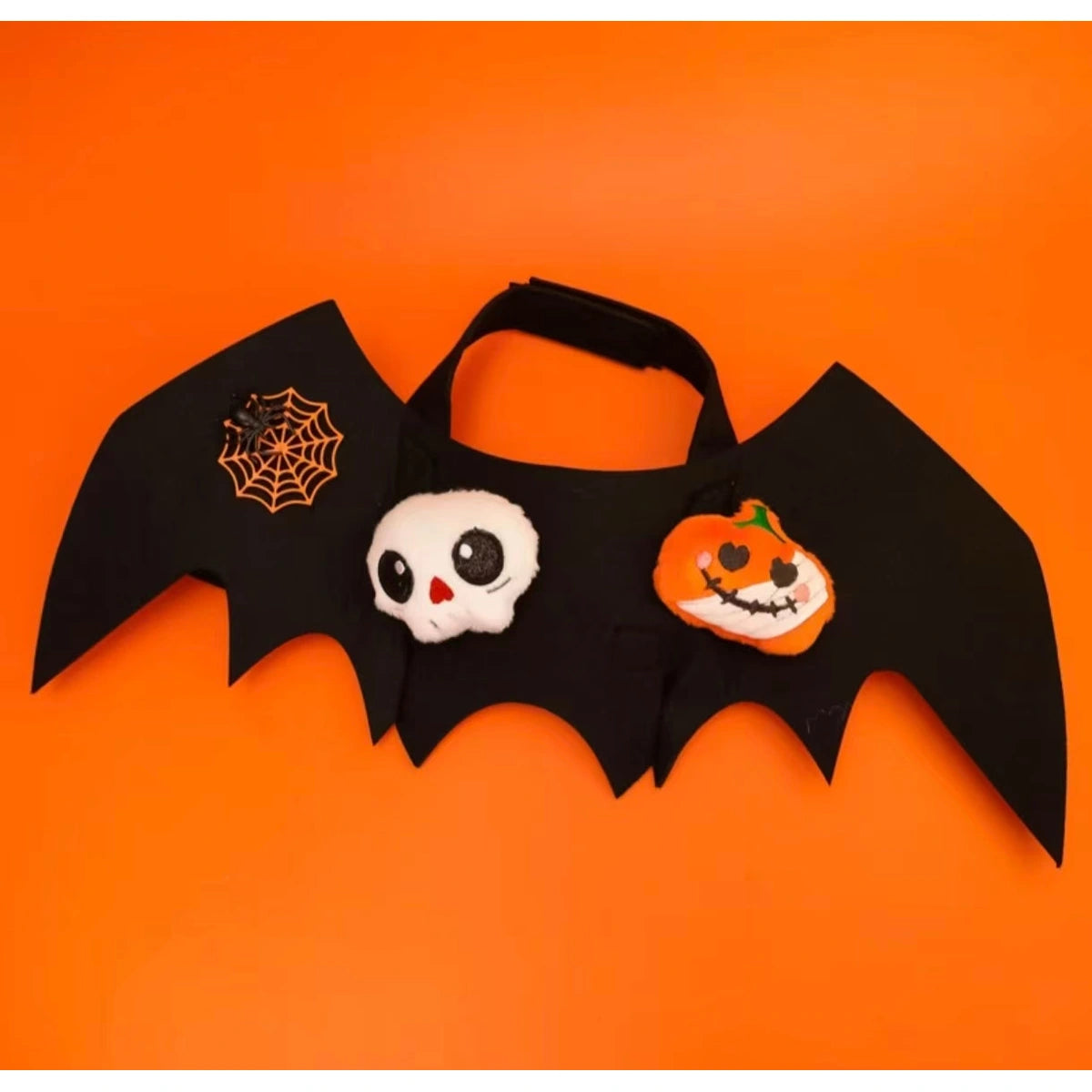 Black bat wings with skull and pumpkin motifs