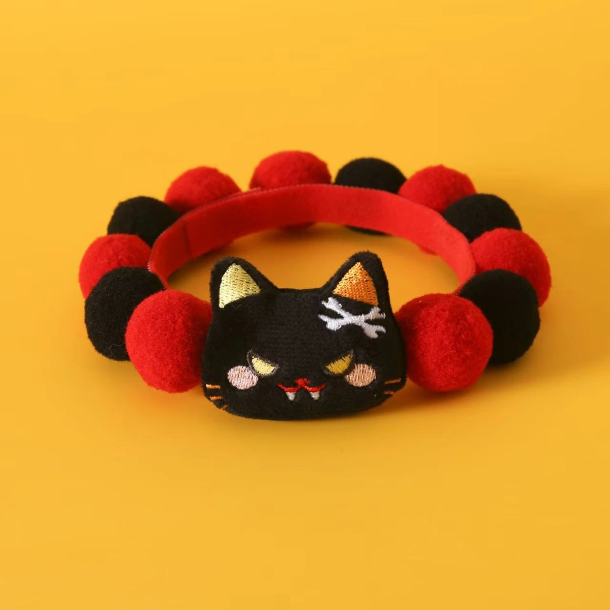 Red and black Halloween cat collar laid flat