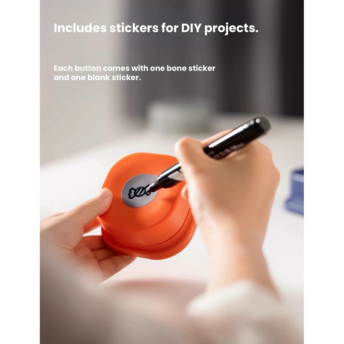 Hand writing a label for an orange MewooFun recordable button