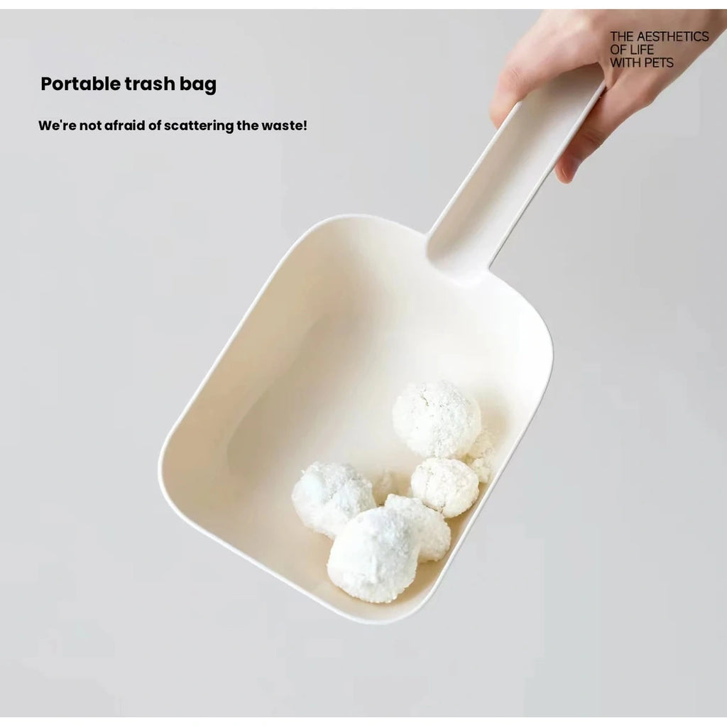 Cream Meoof cat litter scoop lifting a clump from litter