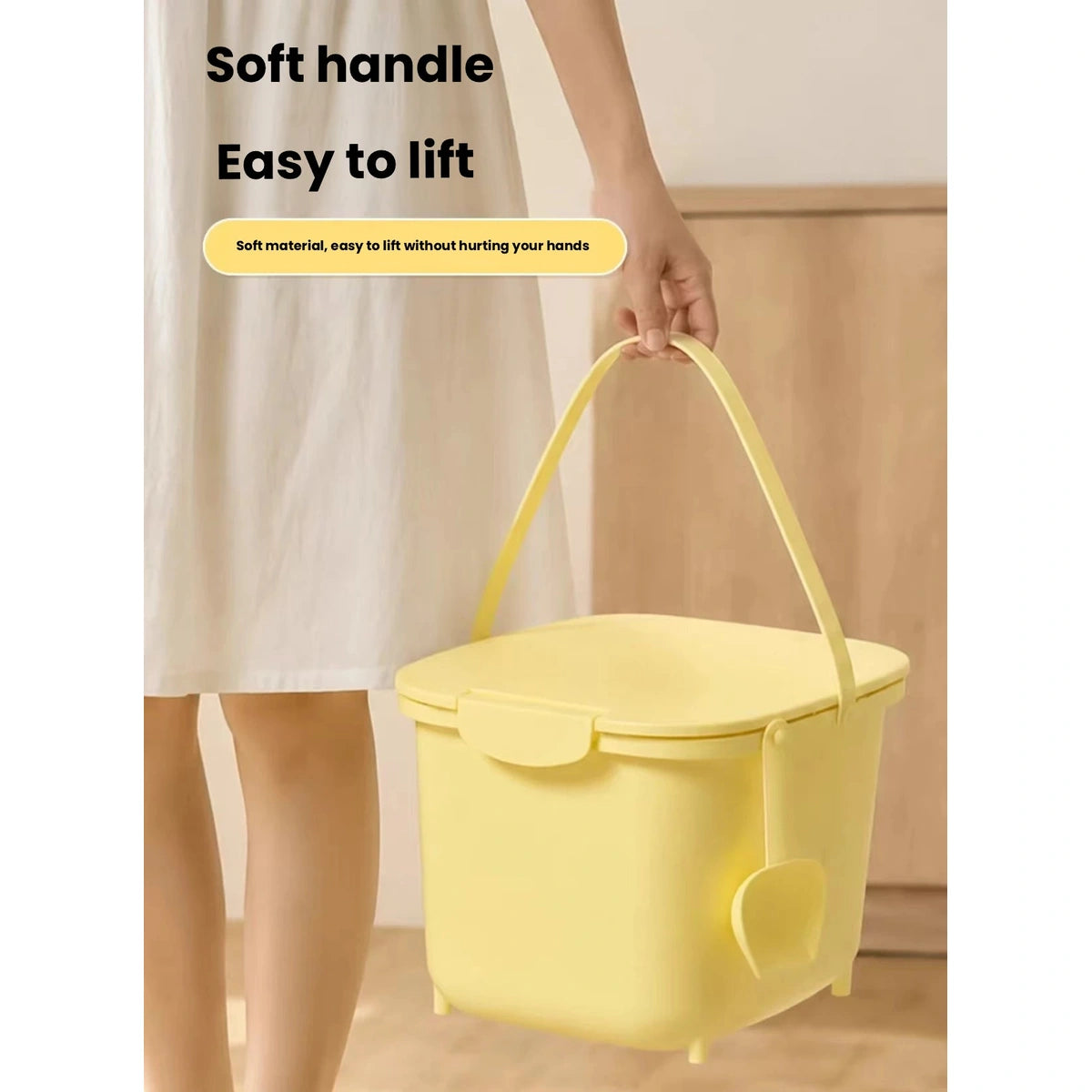 Yellow pet food storage bin carried by its handle