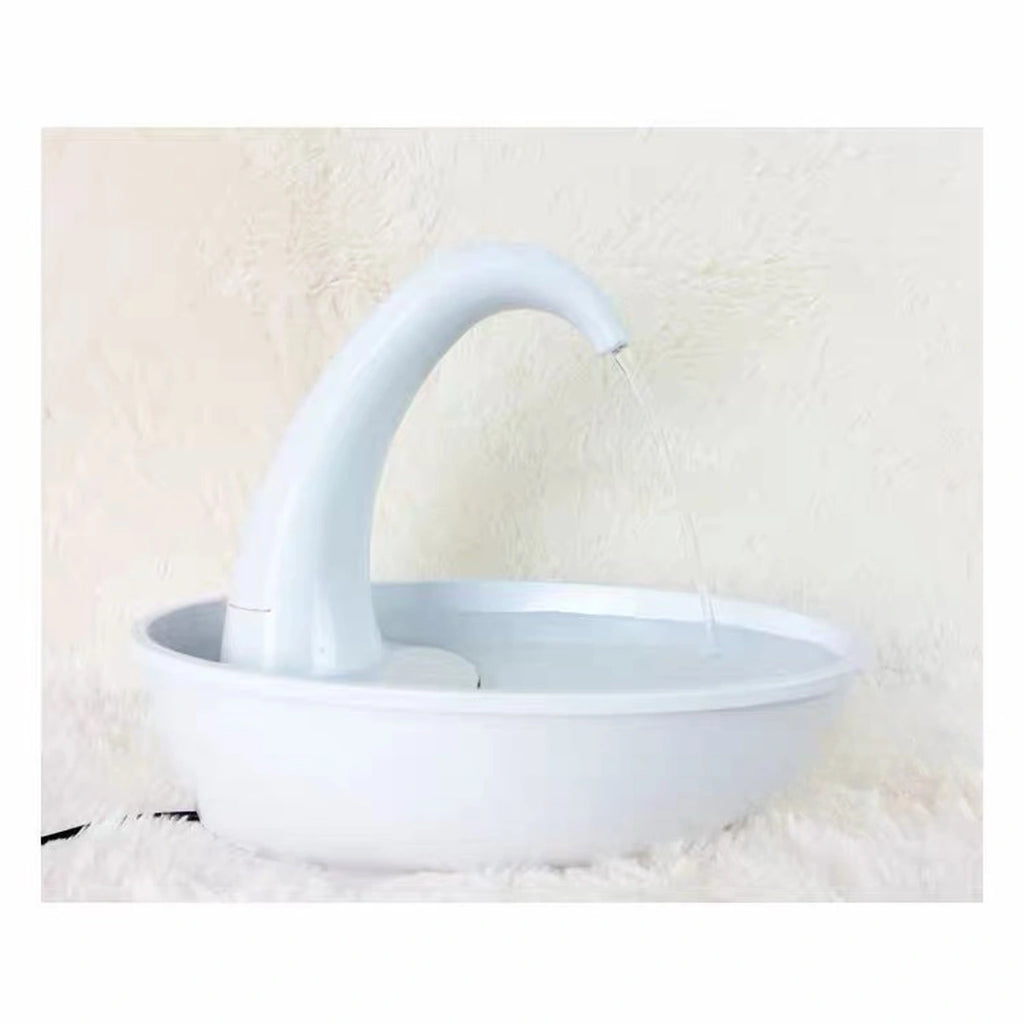 Side view of white Swan drinking fountain