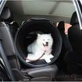 PETSFIT soft-sided dog car crate holding a small white dog in a vehicle