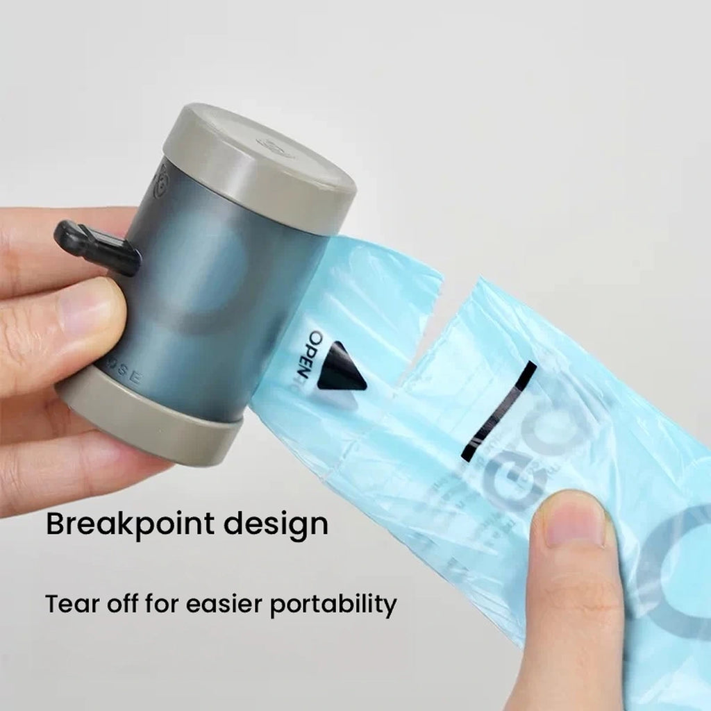 Hand tearing a bag from a Voocoo waste bag roll