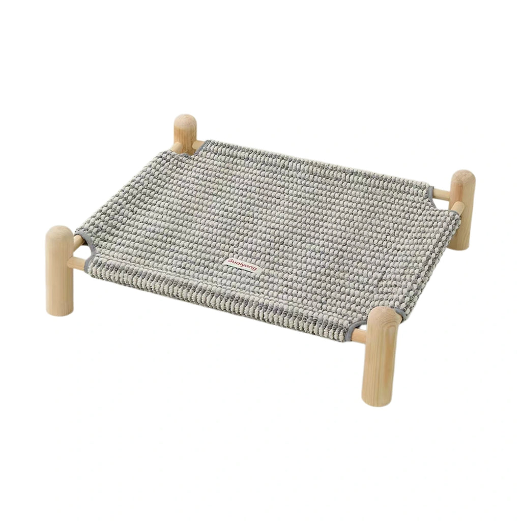 Raised pet cot with a grey woven surface and four wooden-look corner posts