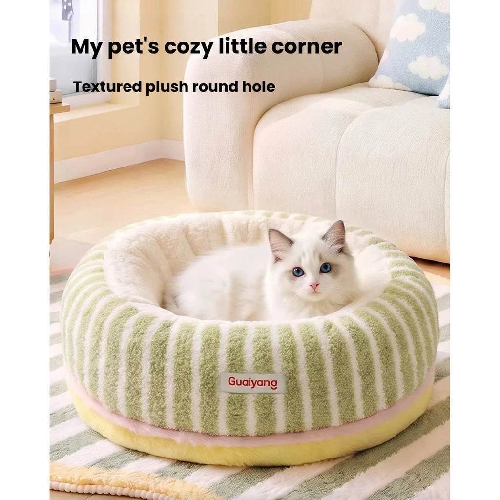 Cat curled up in the green striped pet bed
