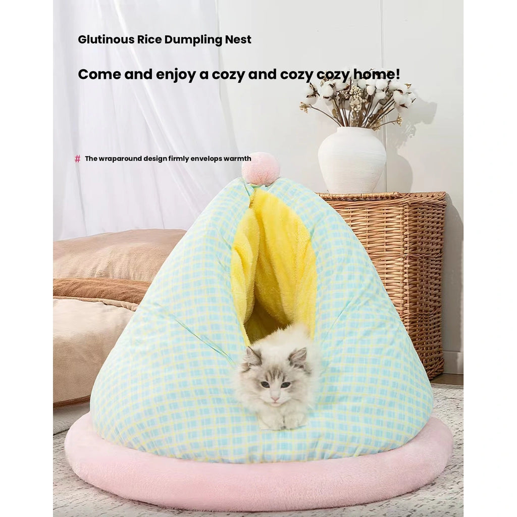 Cat looking out of the mint checked cave bed