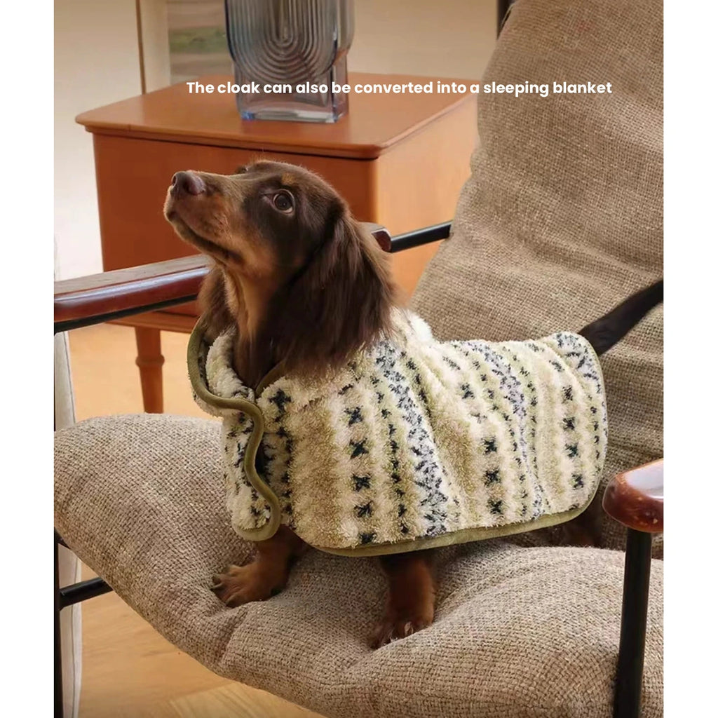 Small dog resting in the olive patterned Petstar cape
