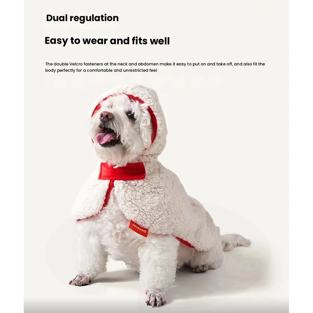 Front view of a white dog in the cream and red Petstar cape