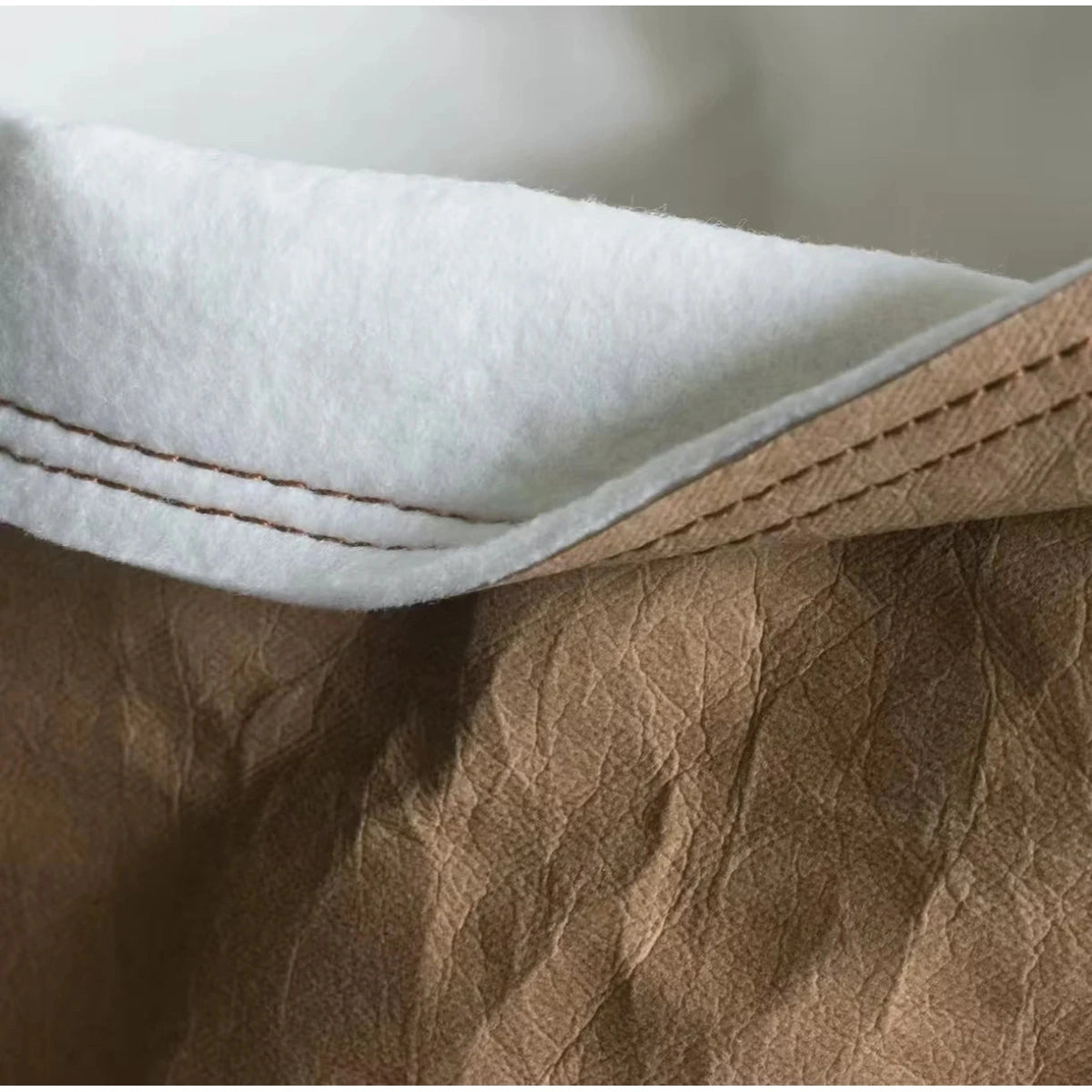 Close-up of the pale cushion and brown paper outer