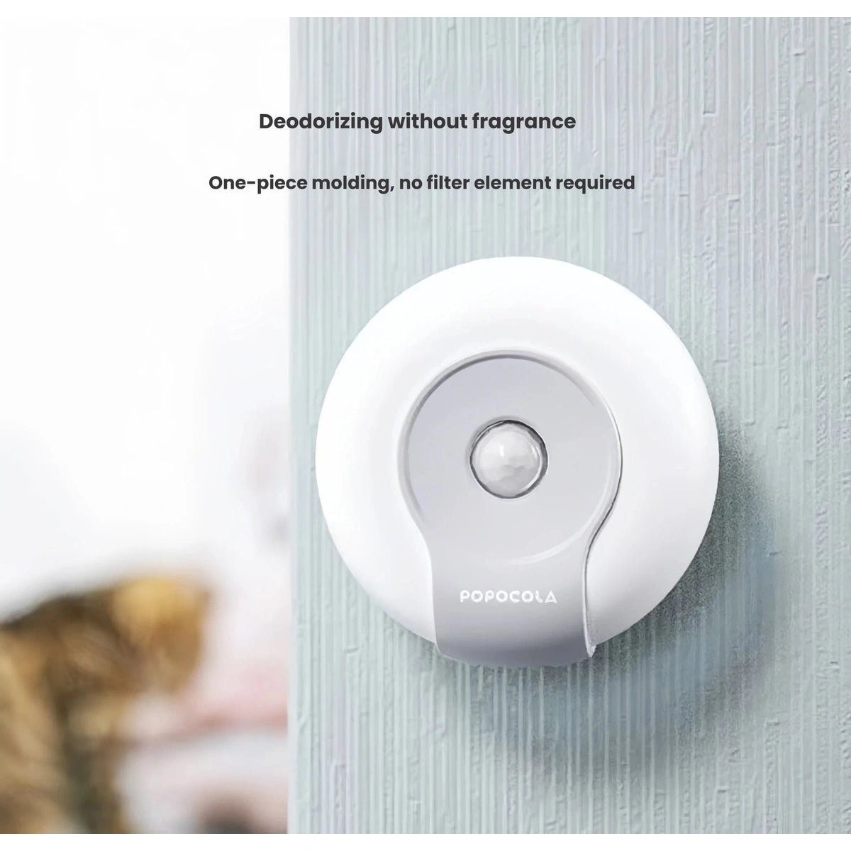 Wall-mounted Popocola litter deodoriser positioned near a cat