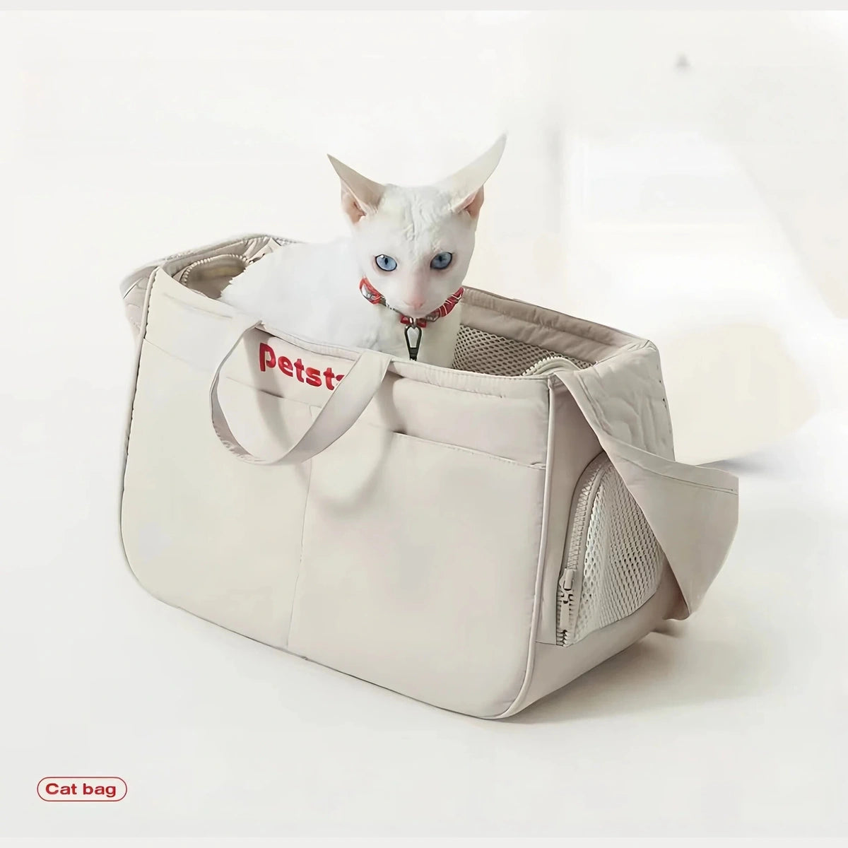Cat sitting in the ivory Petstar tote with mesh side panel visible