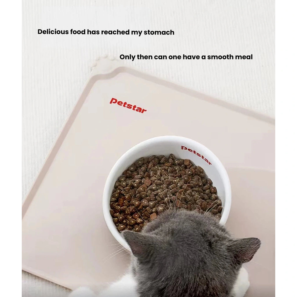 Cat eating from a bowl positioned on the Petstar silicone feeding mat