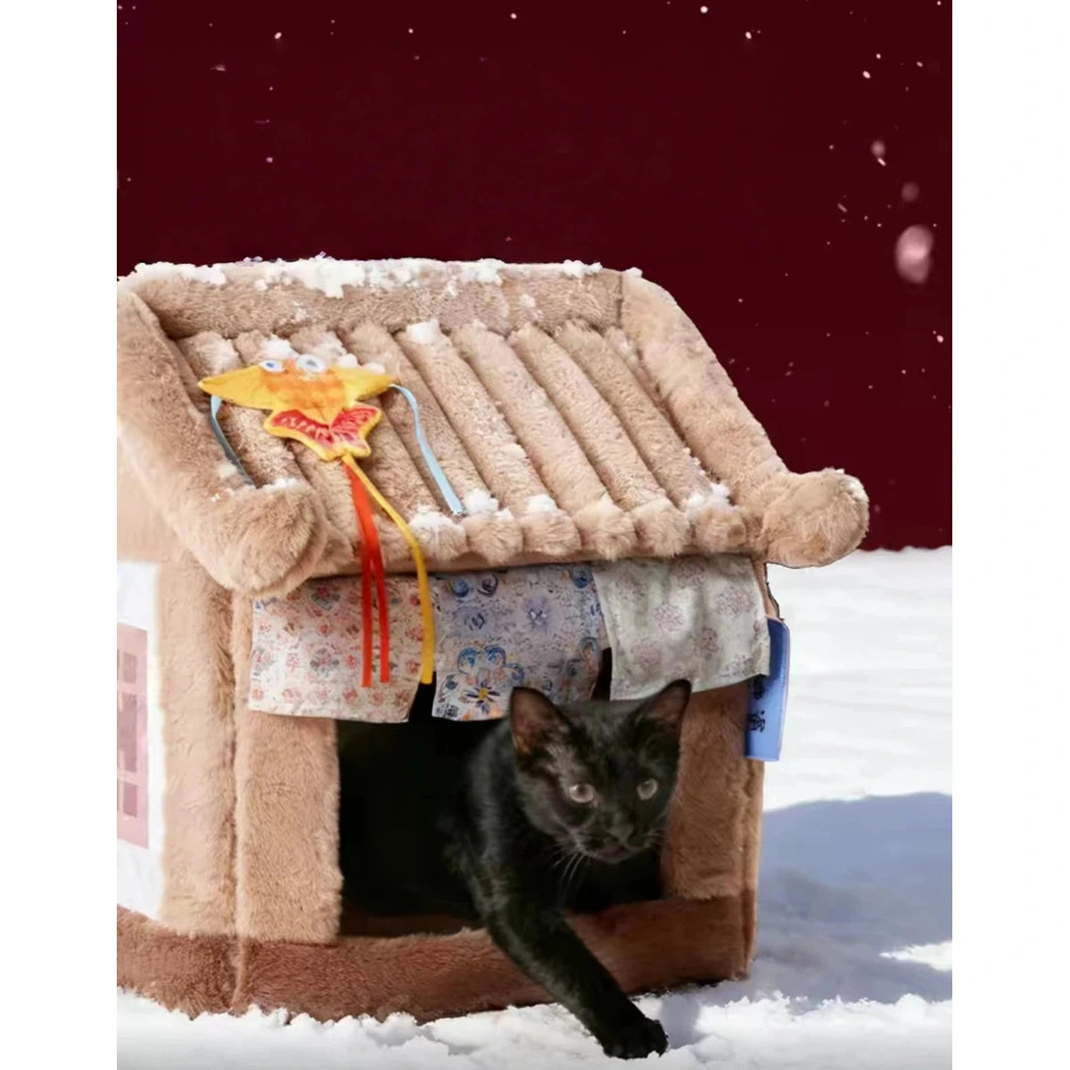 Black cat stepping through the doorway of the Petstar beige cat house