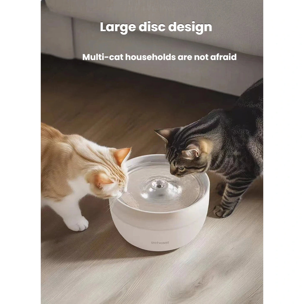 Two cats drinking from the round Petwant water fountain