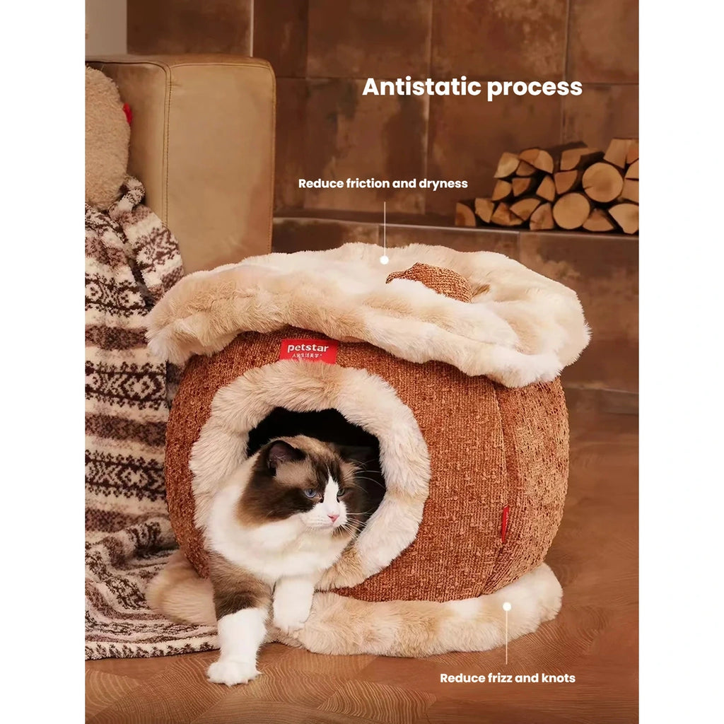 Cat peeking from the plush-lined entrance of the cave bed