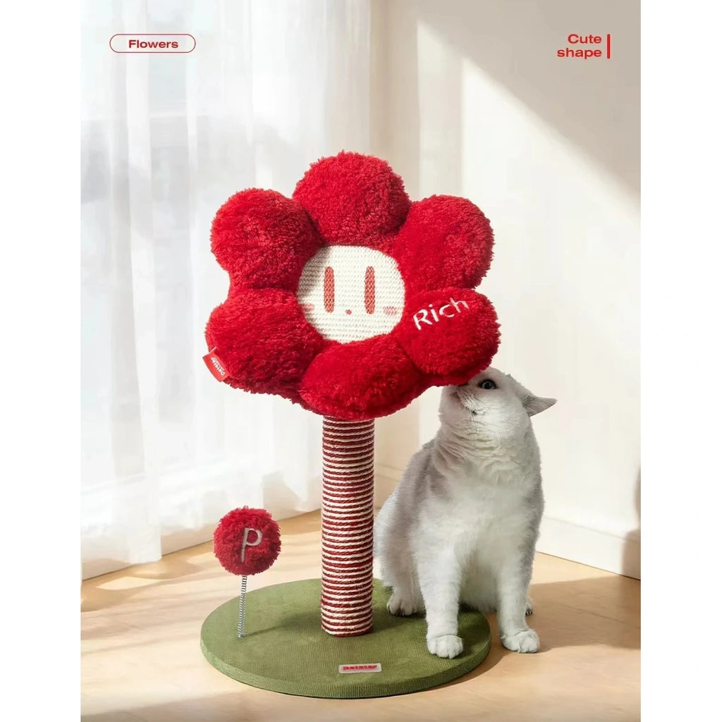 Cat sitting inside the red flower-shaped upper bed