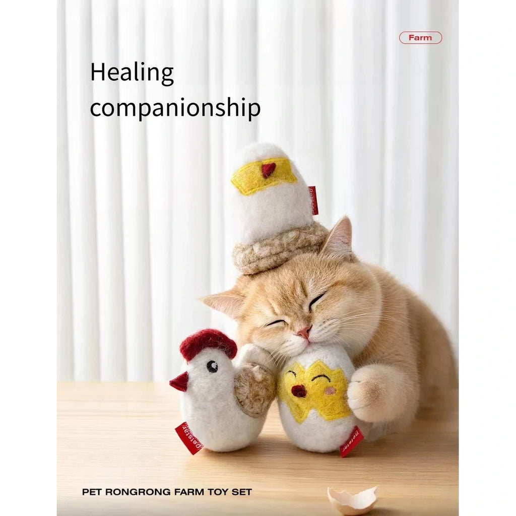 Cat cuddling the Petstar chicken toy set