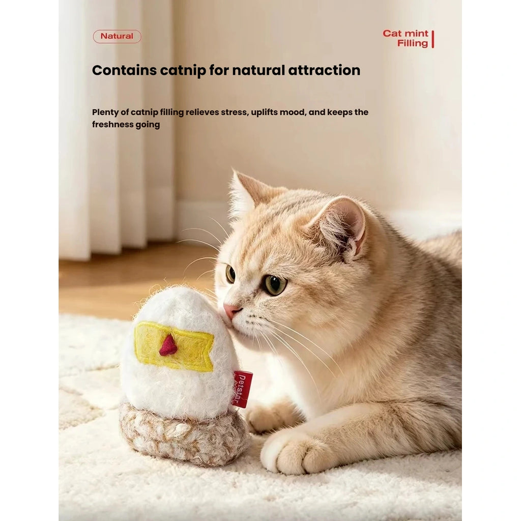 Cat holding a small chicken-shaped Petstar toy